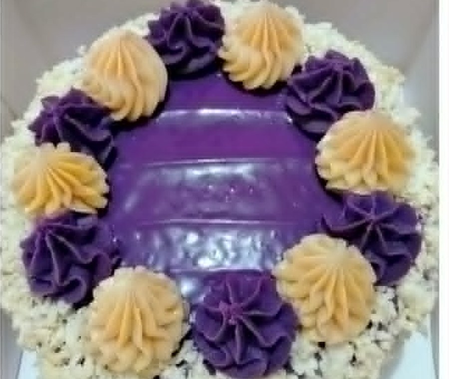 Ube dessert cake with piped cream